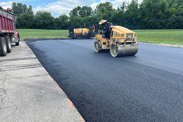 asphalt resurfacing companies near me finishing a project.