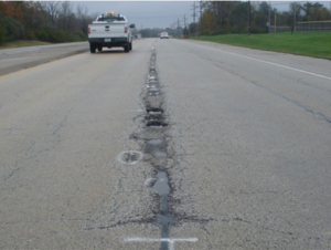 Damaged asphalt joints, front top angle.