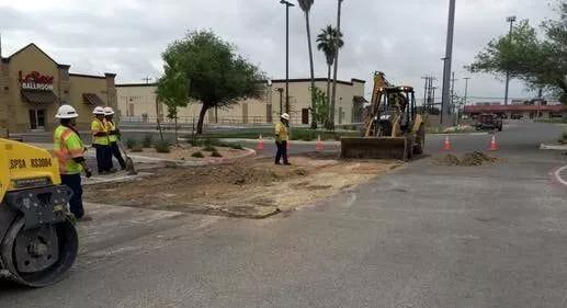 Asphalt paving companies starting a asphalt repair job on a cloudy summer day.